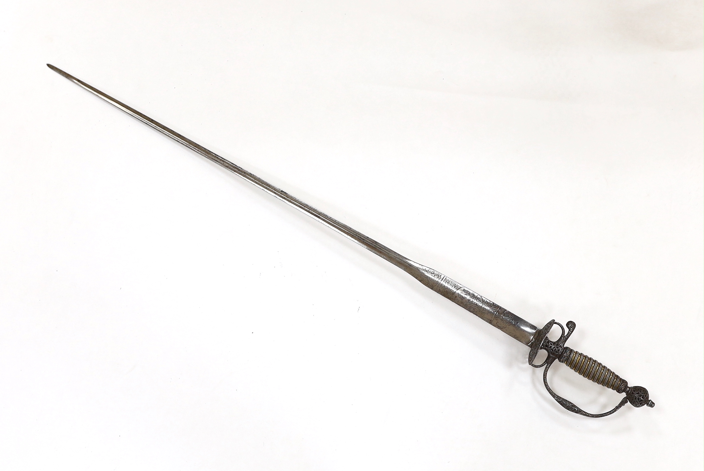 An English iron hilted small sword, c.1765, chiselled and pierced with scrolling devices and foliage, silver gilt tape and silver wire bound grip, colichemarde blade etched with scrolls and squirrel, blade 81.5cm